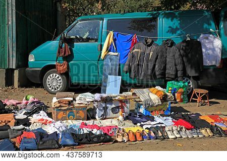 Kiev, Ukraine - October 03, 2020: Street Illegal Trade. Open-air Clothing Market. Cargo Van And Old 