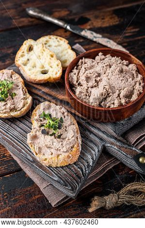 Toasts With Duck Pate Rillettes De Canard On Wooden Board. Dark Wooden Background. Top View