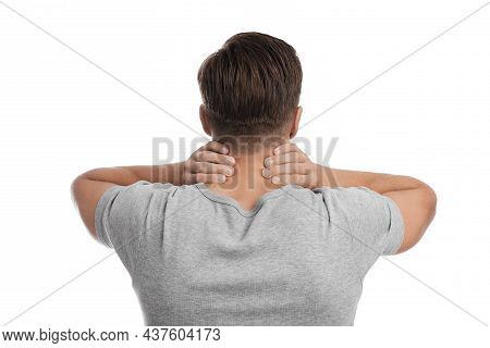 Millennial Caucasian Guy Suffering From Neck Pain, Presses His Hand To Sore Spot
