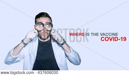 Male Doctor Biologist In A White Coat Compares Two Dangerous Biological Samples Of A New Strain Of C