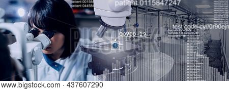Scientist In White Coat Analyzes A Covid 19 Sample Using A Microscope And Computer Data. Wide Format