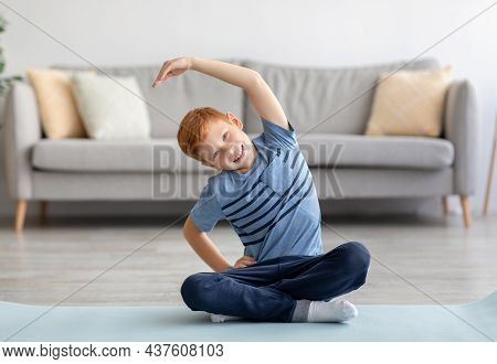 Active Kid Exercising Alone At Home, Doing Strecthing