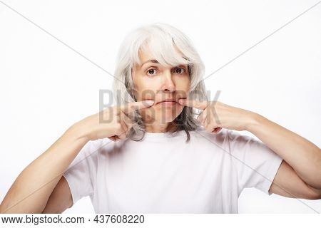 Grandmother with funny expressions isoltaed on white background. Lifestyle and old people concept.