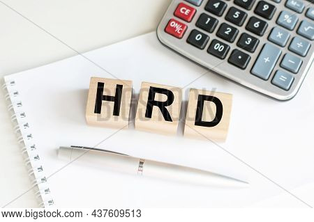 Text Of Hrd On The Wooden Cubes On The Table On A Notebook Next To A Calculator And A Pen