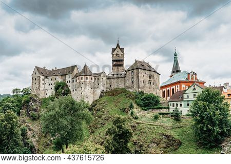 Panoramic View Of Famous Medieval Town Of Loket,elbogen, With Colorful Houses And Stone Castle Above