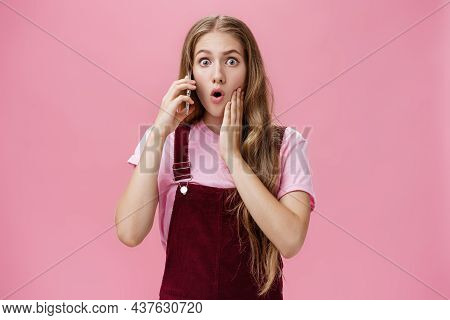 Waist-up Shot Of Shocked Woman Learning Stunning News Via Smartphone Talking On Phone Holding Cellph