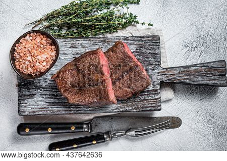 Roasted Shoulder Top Blade Or Flat Iron Beef Meat Steaks On Wooden Board. White Background. Top View