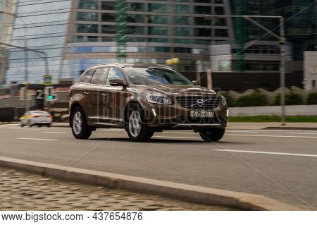 Volvo Xc60 Suv In Motion. Brown Crossover Is Fast Driving On City Street. Front Side View Of Car Rus