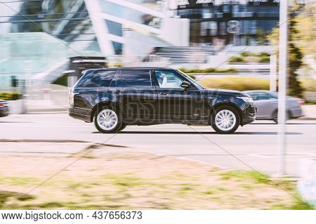 Range Rover L405 Side View. Sport Suv Black Color Driving Against A Background Of Modern Buildings. 