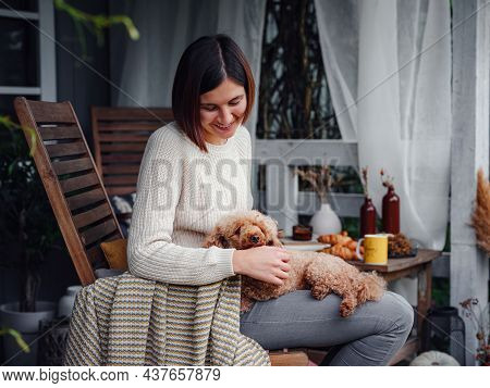 Young Beautiful Woman Resting Outdoors With Cup Of Coffee With Dog.