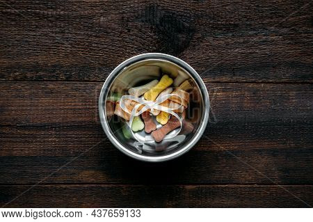 Dog Bone In Bowl On Wooden Background. Artificial Bones And Mini Tiny Treats For Pets. Long Lasting 