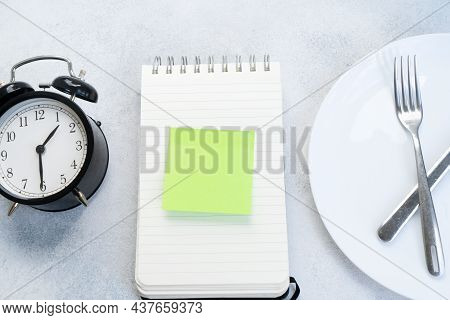 Intermitted Farsting Diet Concept - Empty Plate With Fork And Knife And Timer