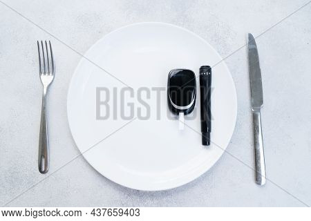 Diabetes Diet Planning Concept, Empty Plate With Fork, Knife And Glukemetr, Fasting Diet And Dieabet