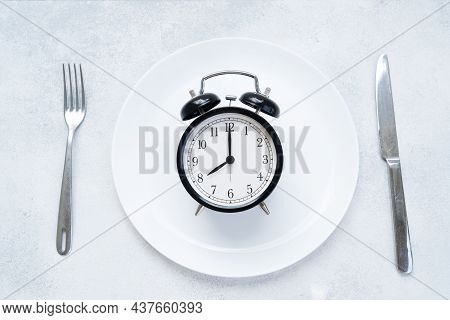 Intermitted Farsting Diet Concept - Empty Plate With Fork And Knife And Timer