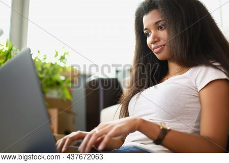 Portrait Of Concentrated Latino American Young Woman Working On Laptop. Girl Typing On Keyboard Prep