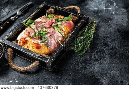 Italian Pizza With Prosciutto Parma Ham, Arugula Salad And Cheese In A Rustic Wooden Tray. Black Bac