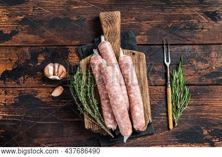 Bockwurst Raw Sausages With Pork Meat On A Wooden Board. Dark Wooden Background. Top View