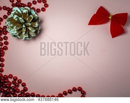 New Year Card. Christmas Card On A Pink Background. Decorations For The Holiday.
Red Bow, Red Beads 