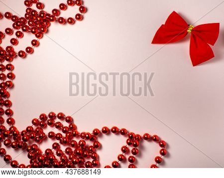 New Year Card. Christmas Card On A Pink Background. Decorations For The Holiday.
Red Bow And Red Bea