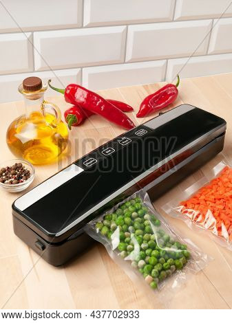 Vacuum Packing Machine. For Long-term Storage Of Food. Packs Green Peas. Top View Light Background.