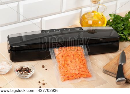 Vacuum Packing Machine. For Long-term Storage Of Food. Packs Chopped Carrots. Top View Light Backgro