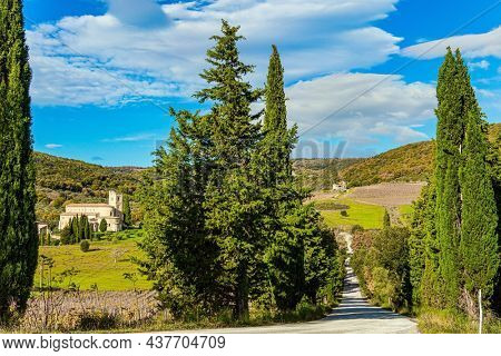 Charming abbey among vineyards and fields. Abbey of Sant Antimo. Magnificent Italy. The magical beauty of the province of Tuscany. Sunny day at the beginning of winter