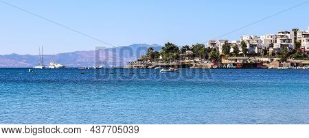 Blue Sea, Boats, Mountains And Small Town On The Coast Of The Aegean Sea. Summer Holidays Concept