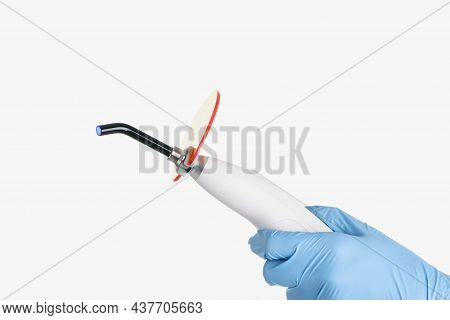 Close-up Of Dentist Tool, Equipment For Tooth Treatment, Cure Procedure. Man In Protective Glove Hol