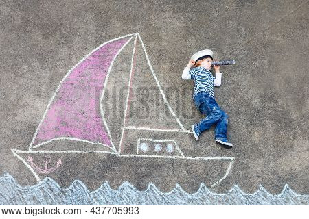 Little Preschool Boy As Pirate On Ship Or Sailingboat Picture Painting With Colorful Chalks On Aspha