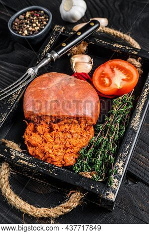 Mallorcan Sobrassada Cured Pork Meat Sausage In A Wooden Tray. Black Wooden Background. Top View