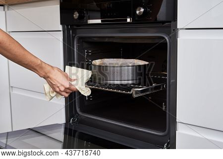 Woman Open Electric Oven Door To Chek In Baking Cake. Homemade Cooking. Kitchen Appliance