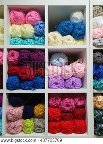 Colorful Yarns Or Balls Of Wool For Knitting On Shelves In The Haberdashery Shop. Knitwork Handcraft