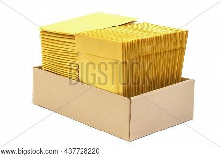 Two Stacks Of Cushioned Mailers In A Kraft Cardboard Box Isolated On White