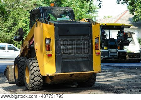 Modern Skid Loader On City Street. Road Repair Service