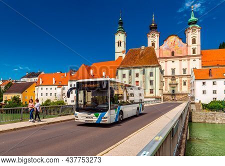 Steyr - June 2020, Austria: View Of The Steyr Bridge With A Modern Bus, Walking Girls, And St. Micha