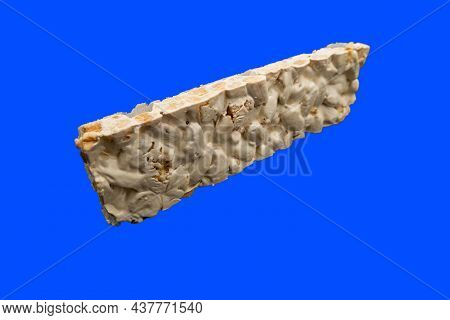 Perspective View Of Christmas Turron Over Blue Background.