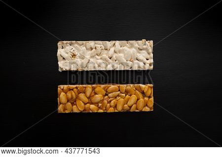 Top View Of 2 Different Types Of Spanish Turrons On Black Background