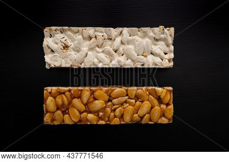 Top View Of 2 Different Types Of Spanish Turrons On Black Background