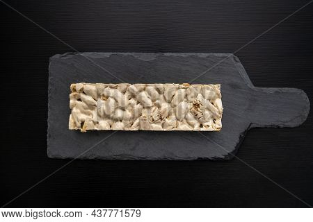 Top View Of Christmas Turron Over Black Background.