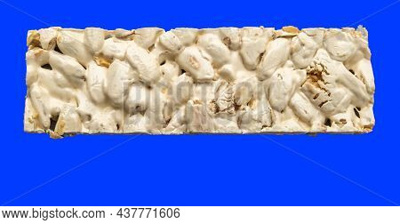 Top View Of Christmas Turron Over Blue Background.