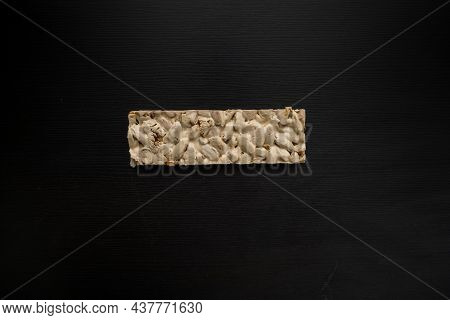 Top View Of Christmas Turron Over Black Background.