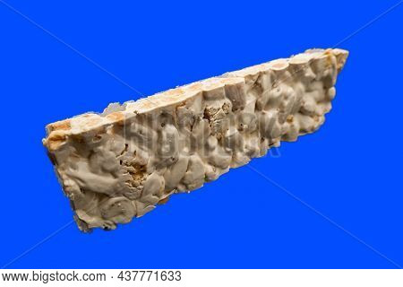 Perspective View Of Christmas Turron Over Blue Background.