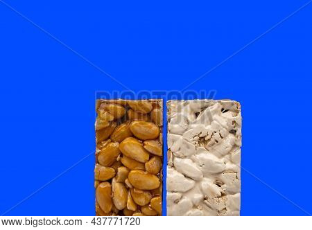 Top View Of 2 Different Types Of Spanish Turrons On Blue Background