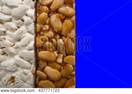 Top View Of 2 Different Types Of Spanish Turrons On Blue Background