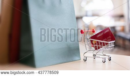 Select Focus On Mock Up Credit Card And Supermarket Cart With Shopping Bags On Table