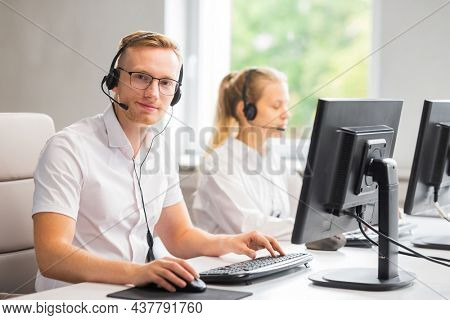 Diverse team of young professionals is working in the phone support office. Working day of sales managers in the call center. Business, telephone consulting and problem solving.