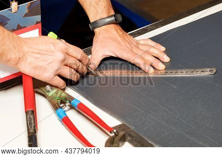 The Male Hands Of The Worker Mark Out A Sheet Of Roofing Iron With A Pencil And A Metal Ruler For Th