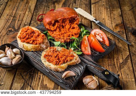 Tapaa Sandwichs With Sobrassada Cured Pork Meat Sausage And Tomato On A Wooden Cutting Board. Wooden
