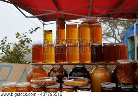 Jars Of Organic, Natural Honey On The Counter For Sale. Different Honey, Different Colors In Glass J