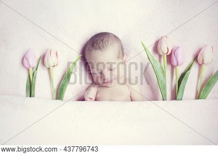 Portrait Newborn Girl Lies And Sleep On Pink Soft Blanket With Tulips Flower Around Her. Beautiful C